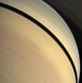 Rendered in myriad hues, vivid details of Saturn\'s stormy atmosphere play out below the shadow of the rings.